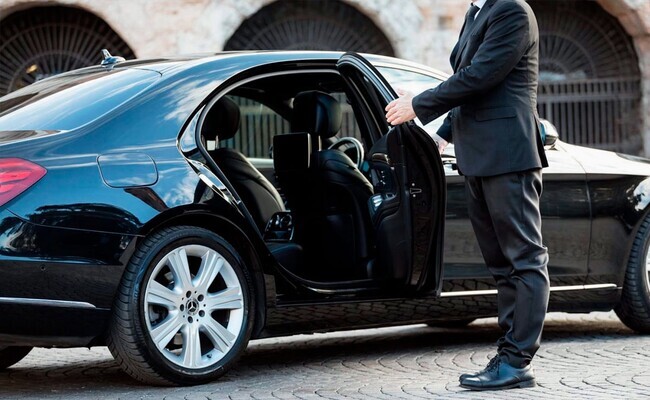 Business professional working in luxury car