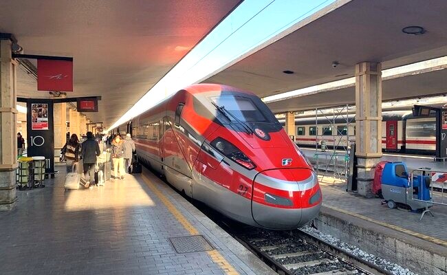 Luxury car waiting outside train station