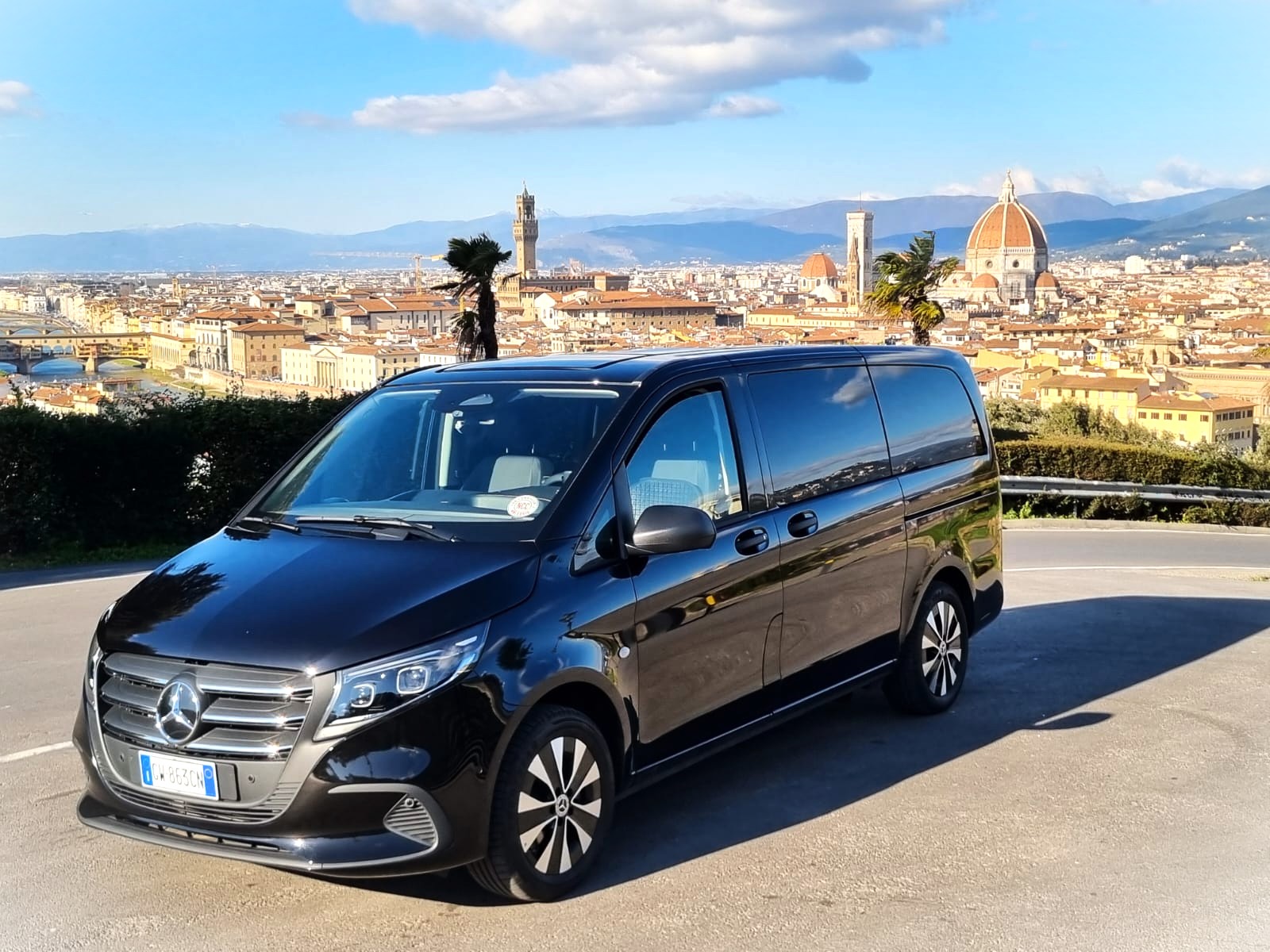 A sleek, modern black Mercedes-Benz Vito luxury passenger van parked at an angle, showcasing its professional exterior design.