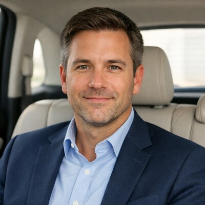 American business traveler seated in a premium private transfer vehicle in Tuscany