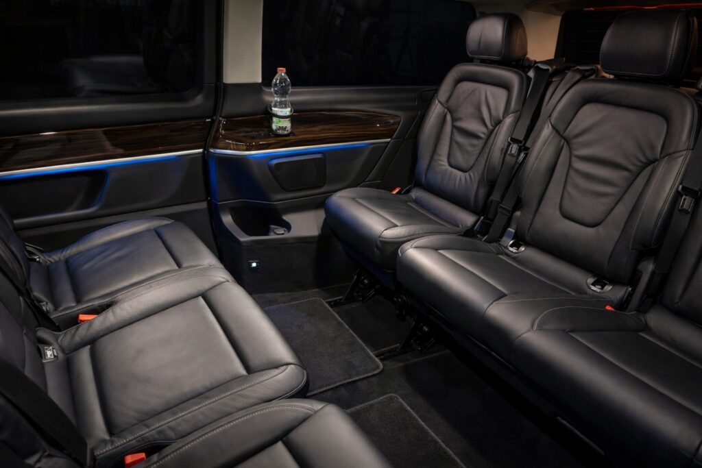 Spacious interior of a Mercedes V-Class luxury van with vis-à-vis seating for group transfers in Florence and Tuscany.