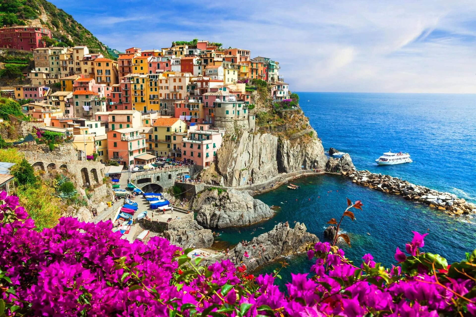 Manarola village in Cinque Terre with colorful houses overlooking the sea, luxury private chauffeur service experience