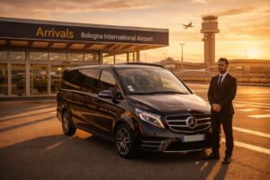 Black Mercedes V-Class luxury van at Bologna Guglielmo Marconi Airport during golden hour, private chauffeur transfer service.