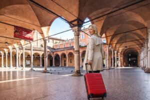 Luxury Florence to Bologna private transfer with black Mercedes V-Class chauffeur vehicle parked in historic Italian city center