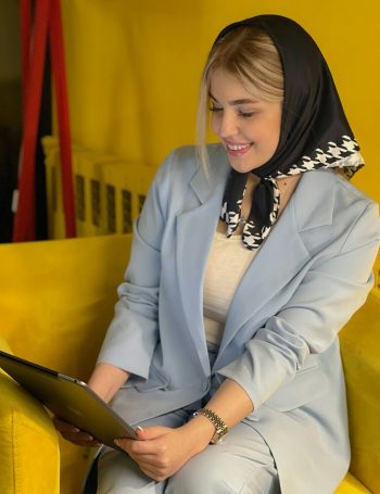 Happy woman looking at laptop with satisfied and joyful expression